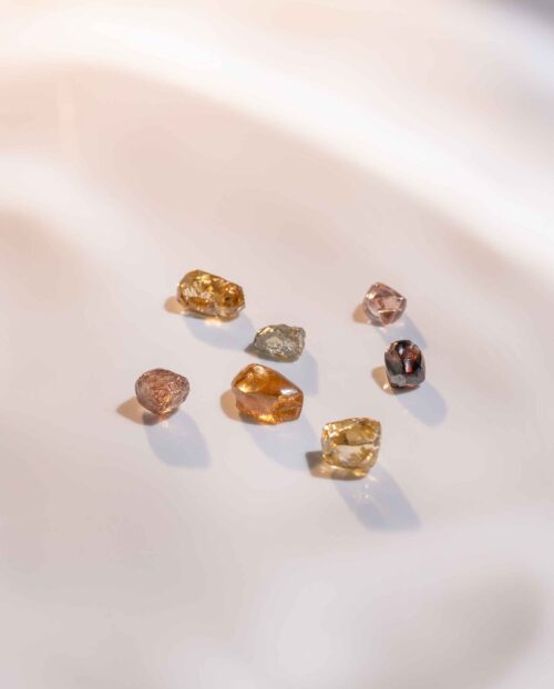 seven colourful stones on a white background