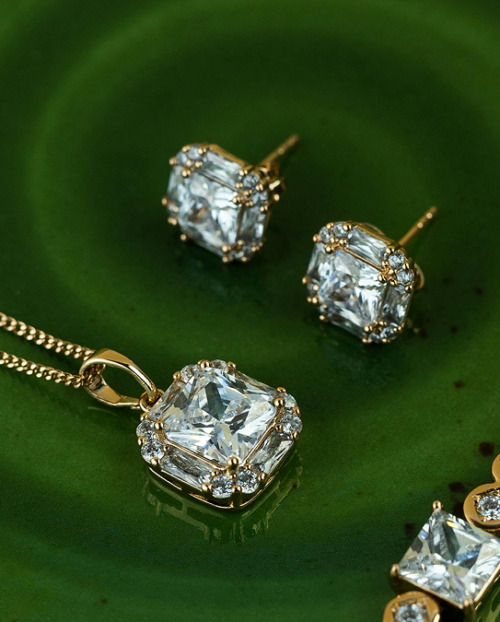 White diamond pieces of jewelry on a green ceramic plate